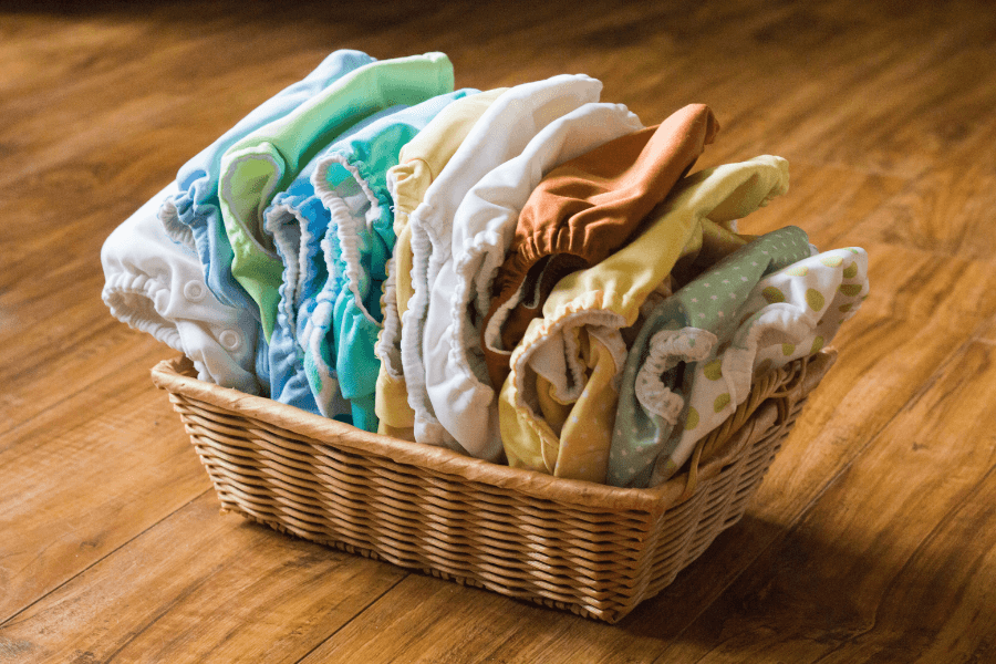 cloth diapers in a basket - cloth diapering tips