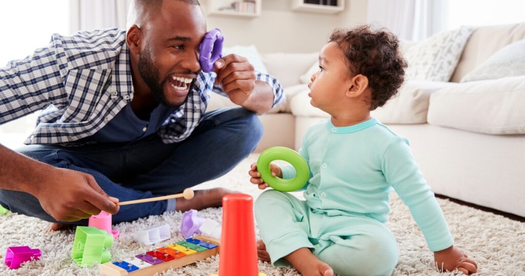 toddler fathers day gifts. Picture of a father and his child playing with toys.